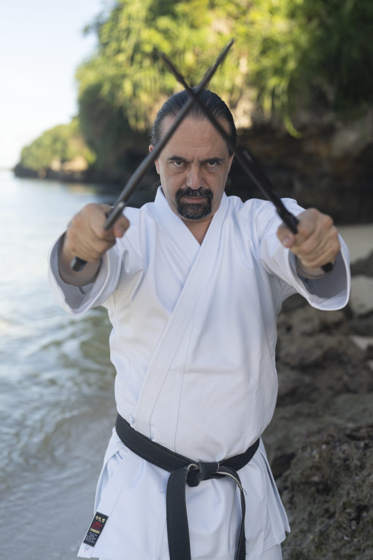 Justin Sheehy with sai on beach